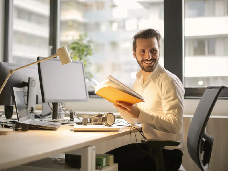 A smiling professional at his desk
