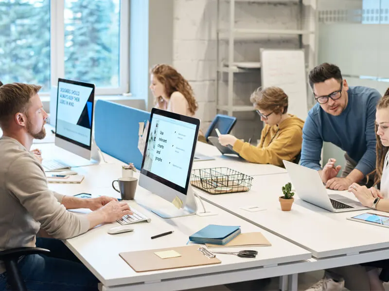 Professionals working at computers in a modern office